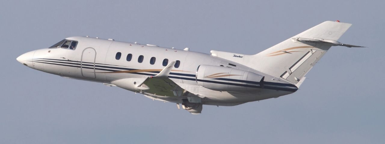  A picture of the Hawker Beechcraft 900XP, a popular midsize aircraft, in the air.