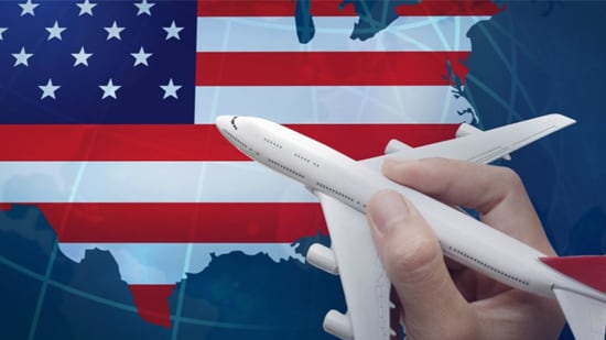  一只手拿着玩具飞机在美国地图上