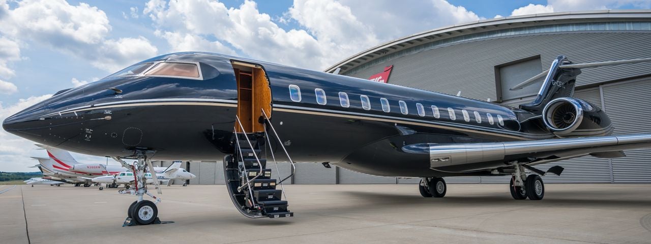 A Bombardier  GIobal 6000 in front of a hangar