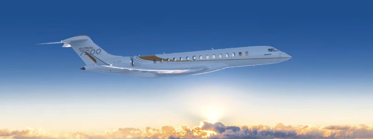 A Bombardier Global 7500 flying above the sunset in the clouds. 