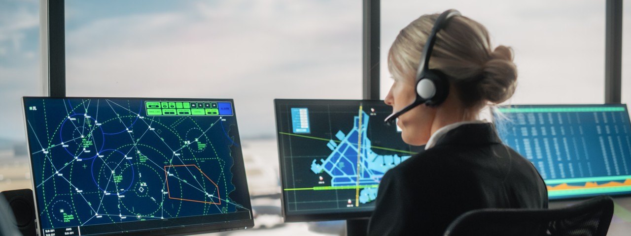 A female air traffic controller monitoring air traffic.