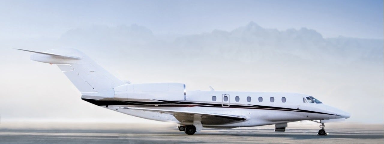 Private jet airplane standing on airfield ready to take off