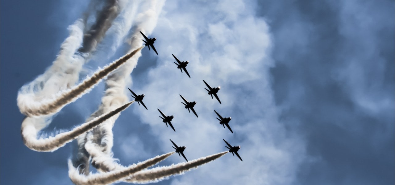 Image of fighter jets flying in formation.