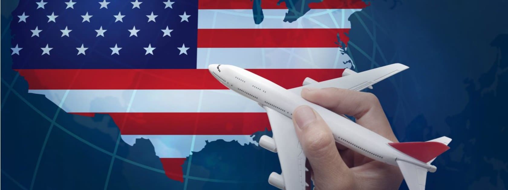  A hand holding a toy airplane over a map of the USA