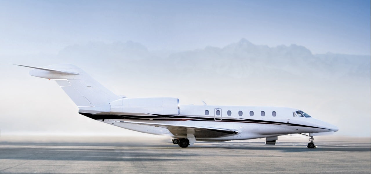 Private jet airplane standing on airfield ready to take off