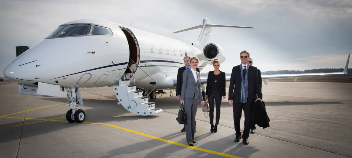 A business team disembarking a private jet