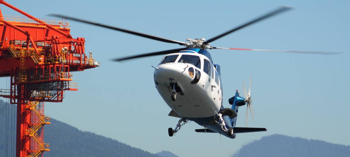 Closeup of white Sikorsky S-76 helicopter about to land 