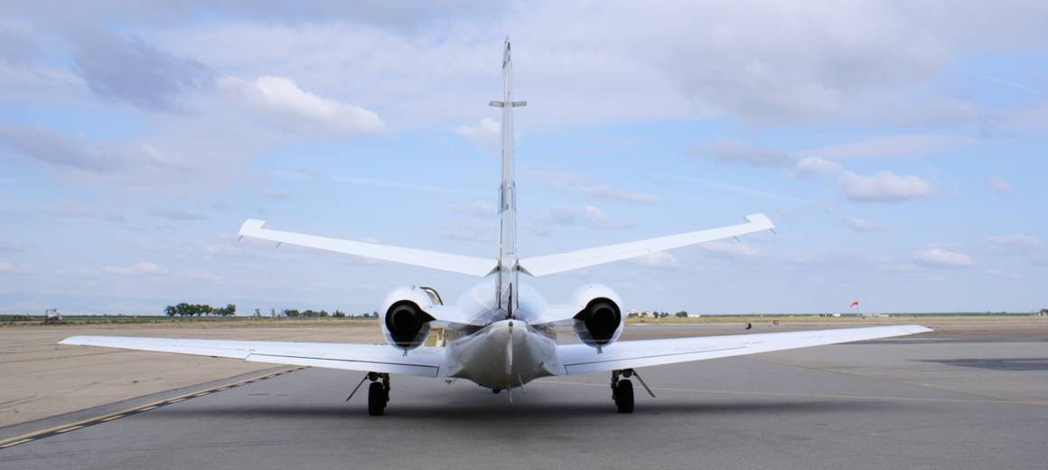 Close-up of the exterior of a Cessna Citation CJ3+ parked at an airport.