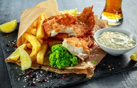 Beer-battered fish and chips with mushy peas.