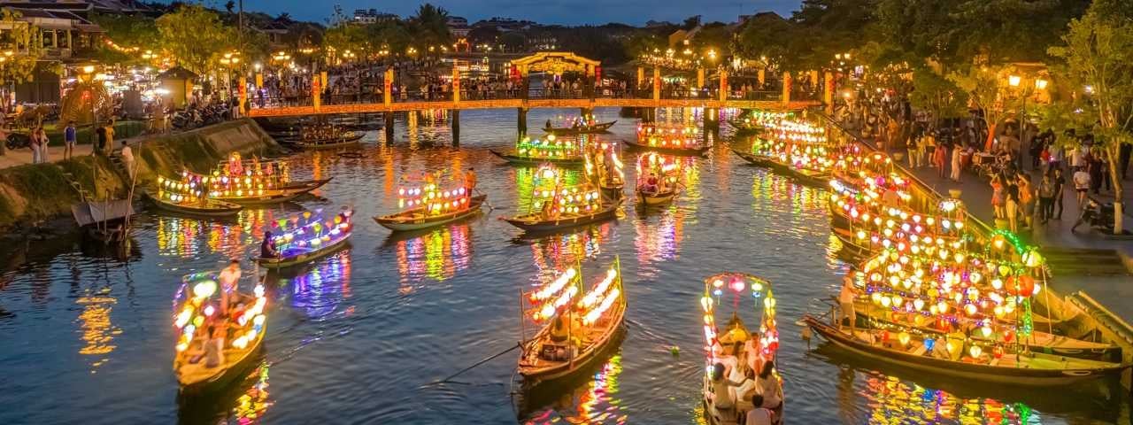 Boats with colored lanterns on a river in Hoi An Ancient Town.