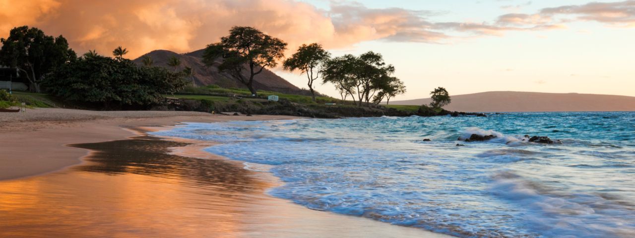 View of a tropical beach in Maui Hawaii at sunset.