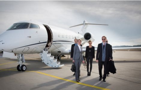 A business team leaving a private jet.
