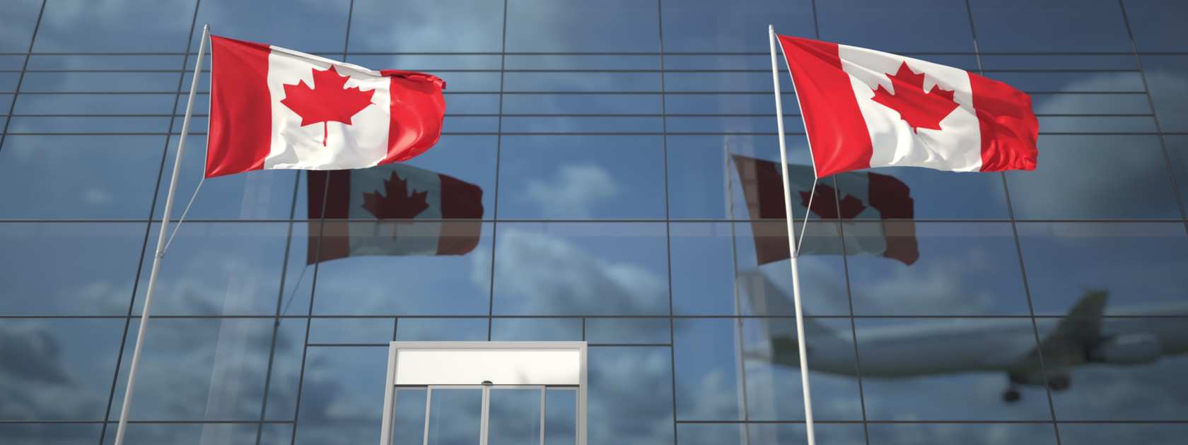 Two Canadian flags in front of the terminal building.