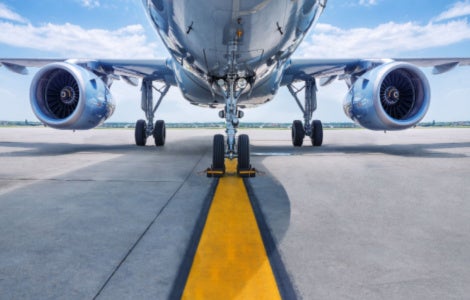 Close-up of the turbines of an aircraft parked on a runway.