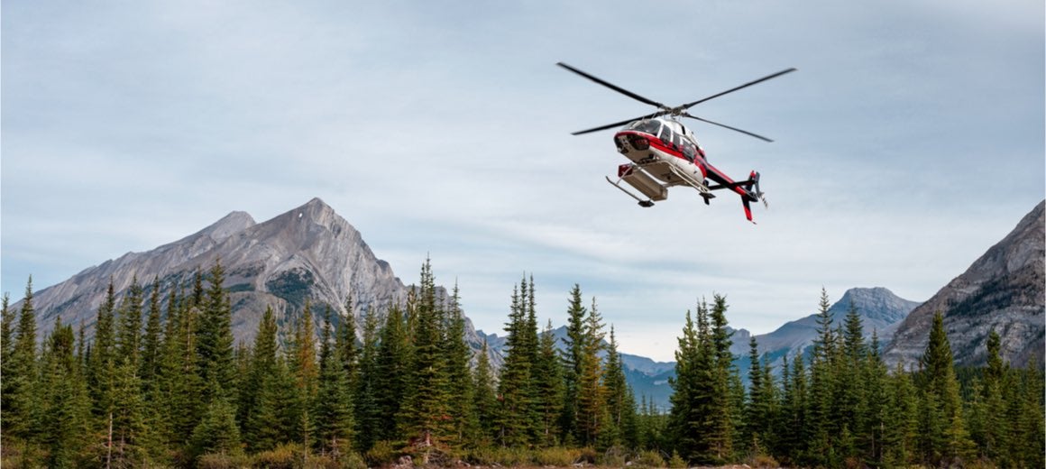 Sightseeing helicopter flying over Banff National Park, Canmore, Canada.