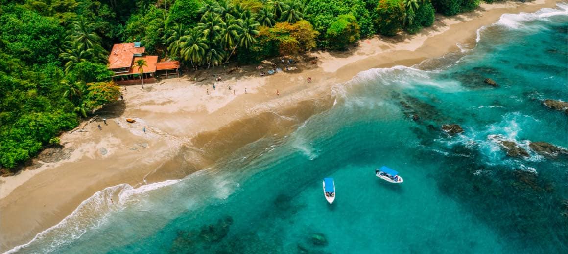 Aerial drone view of a tropical island with a lush jungle in Isla del Caño, Costa Rica.