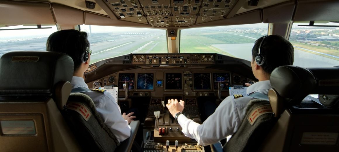 Two pilots in an airplane cockpit.