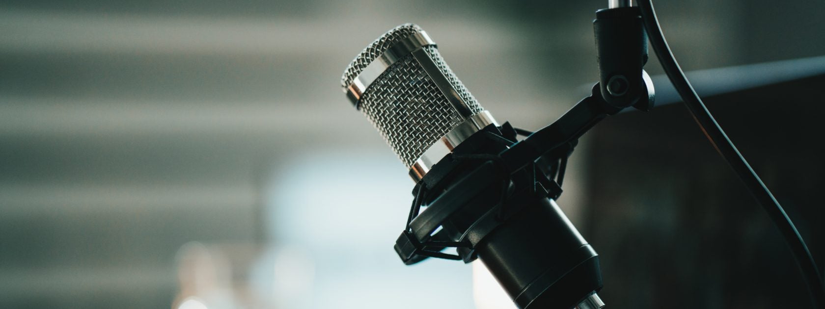 A microphone in front of a laptop.