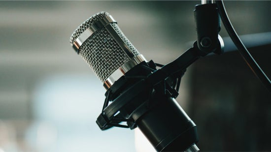 A microphone in front of a laptop.