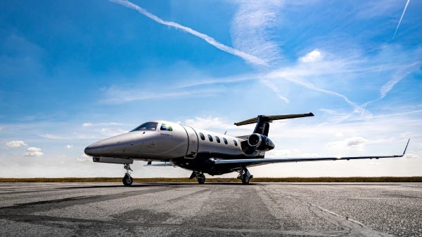 Embraer Phenom 300 on a tarmac.