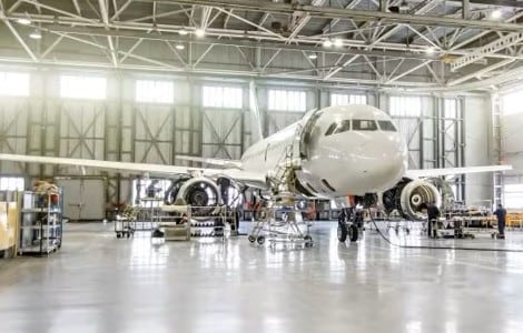 Maintenance being done on a passenger aircraft in a hanger.