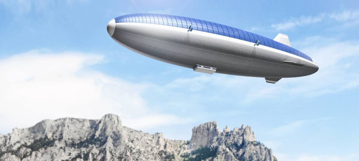 An artist’s impression of a futuristic airship with solar panel roof, drifting over a mountain range