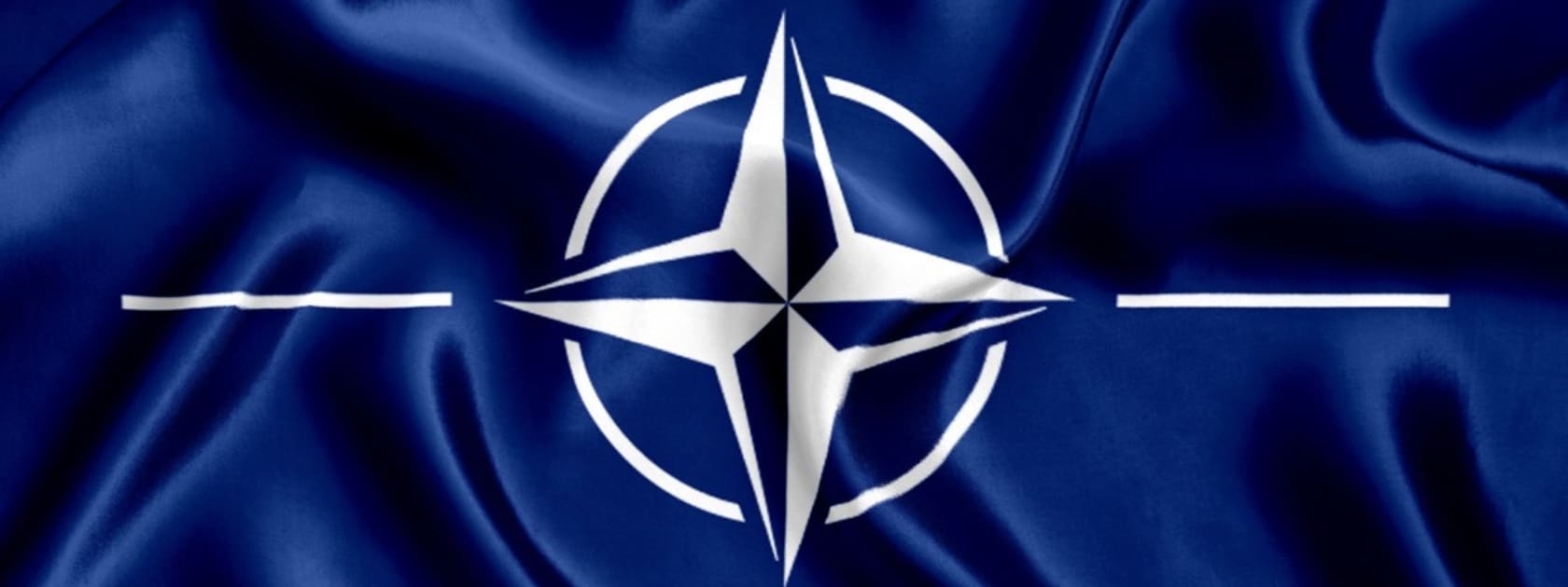 The white four-point NATO star on a blue background