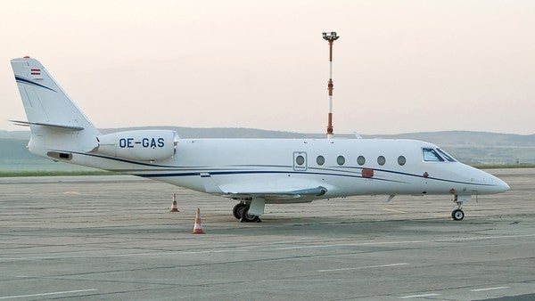 A Gulfstream G150 private jet landing on he runway