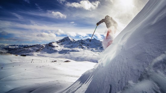 A skier is skiing down the mountain