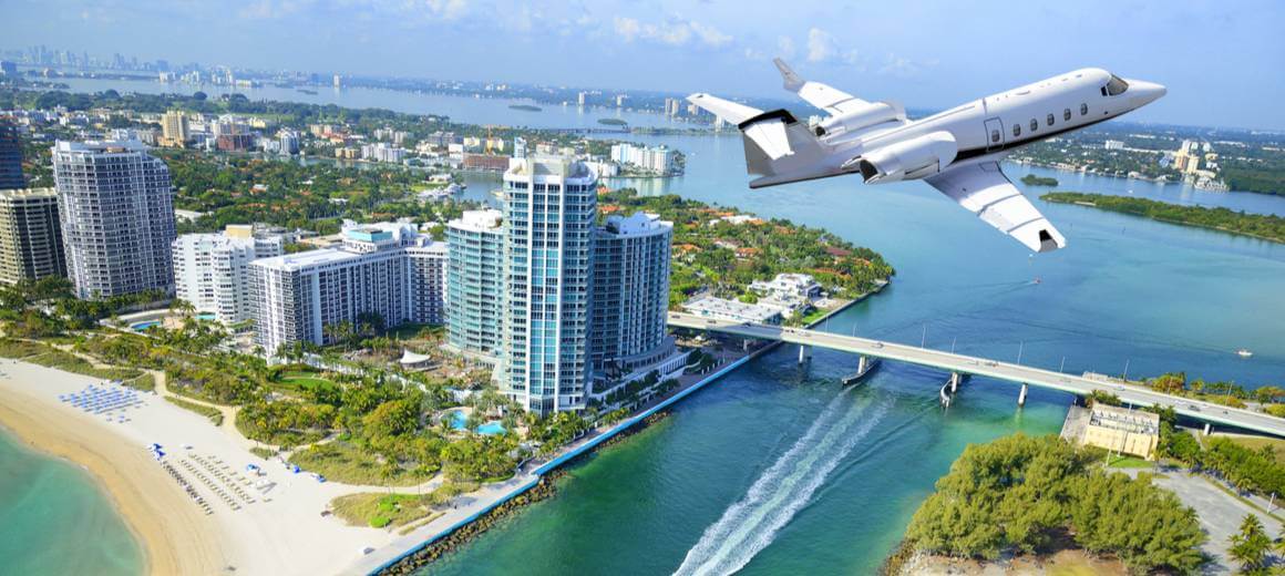Private jet flying over Miami Beach