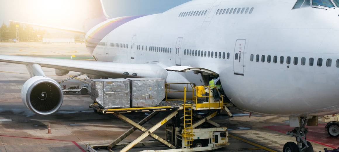 Cargo being loaded into airplane using forklift