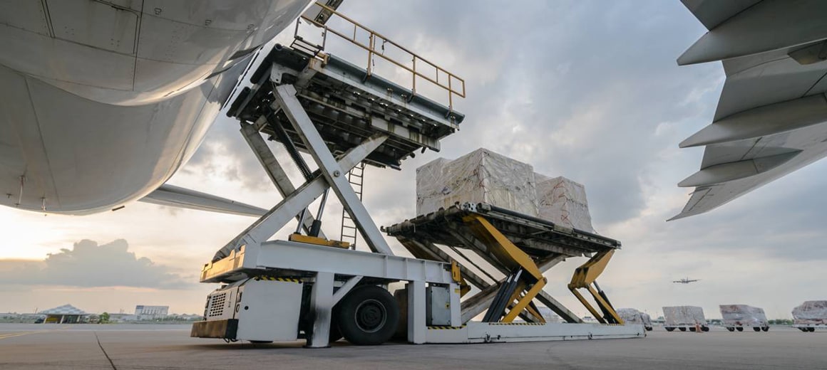 Ground shot perspective of cargo being loaded onto an air cargo plane