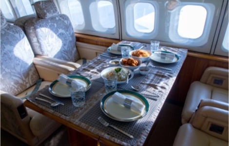 A meal being served on a table in a private jet