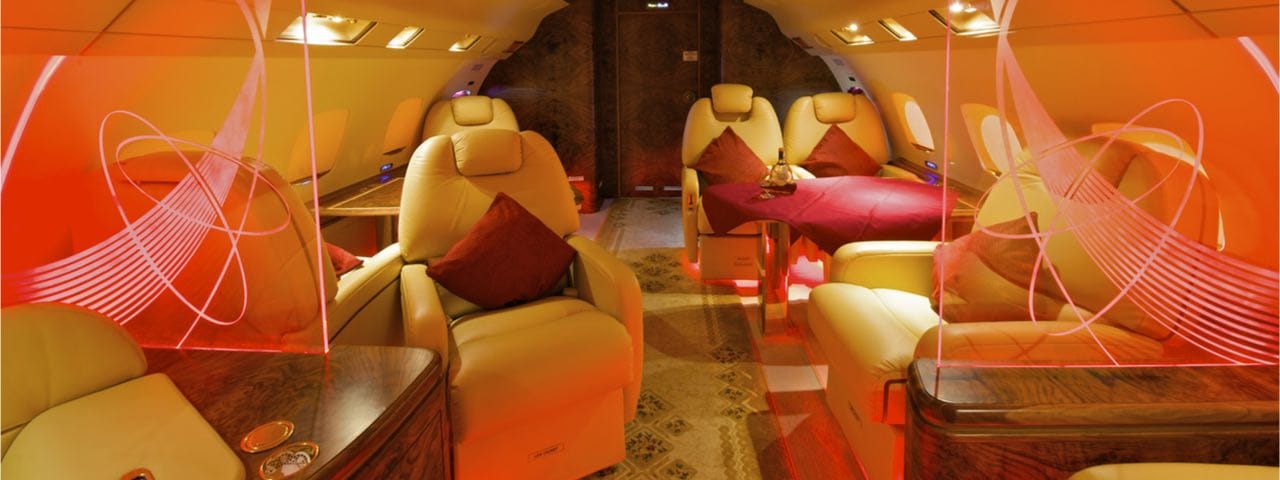 The lavish seating area with a red theme inside a private jet.