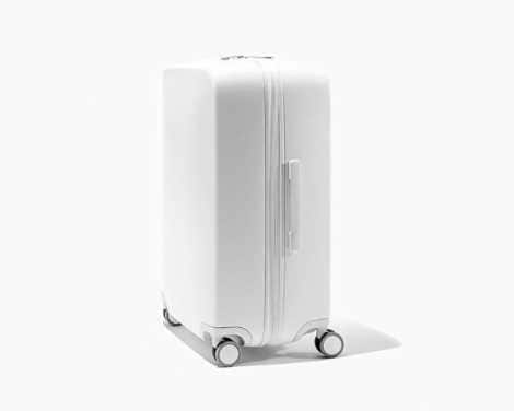 White raden suitcase on white background.