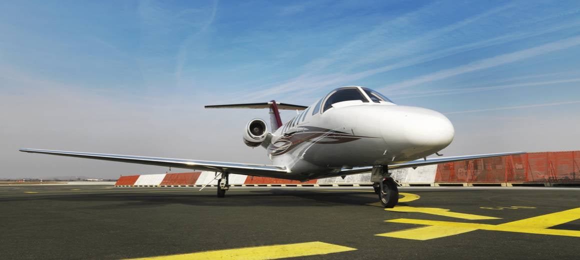 Close up of the exterior of a Cessna Citation CJ3+ parked at an airport