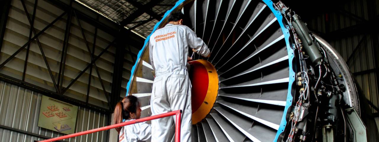 Engineers are working on an airplane engine