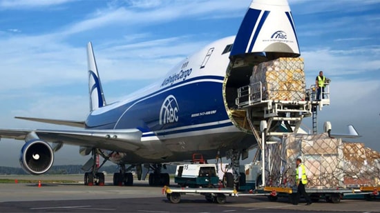 Cargo is being loaded from the front of the airplane.