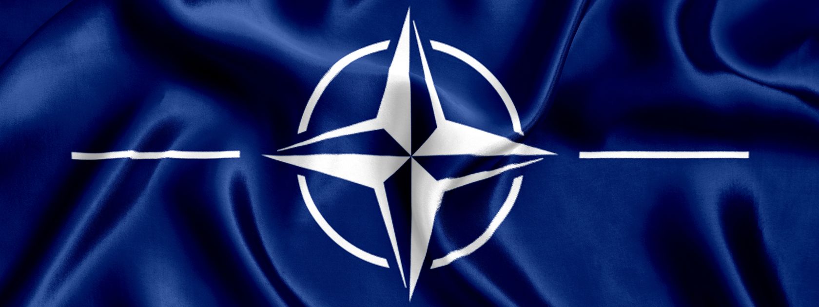 The white four point NATO star on a blue background