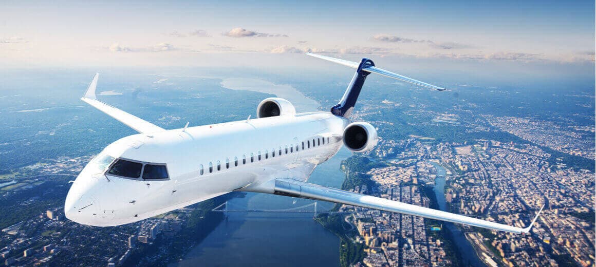 A private jet in flight over a city