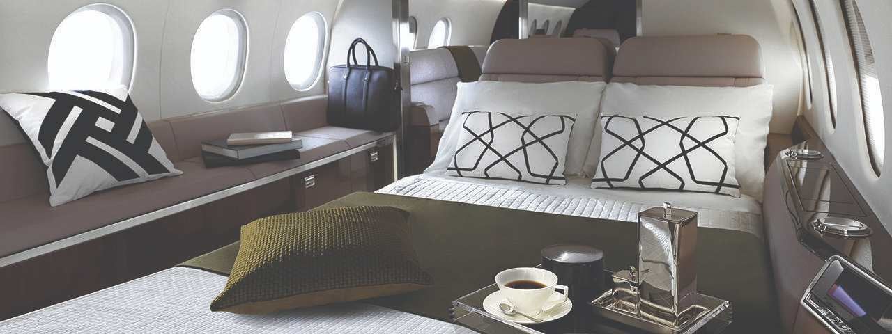 Luxury interior of a private plane with food and drink on the table.