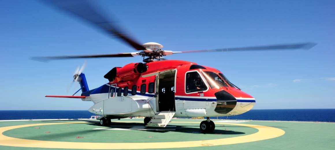 Red and white Sikorsky S-92 helicopter about to take off