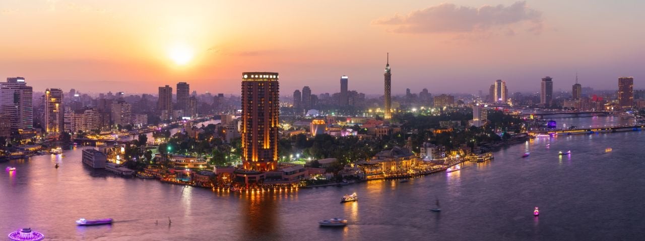 A metropolis on a river at twilight.