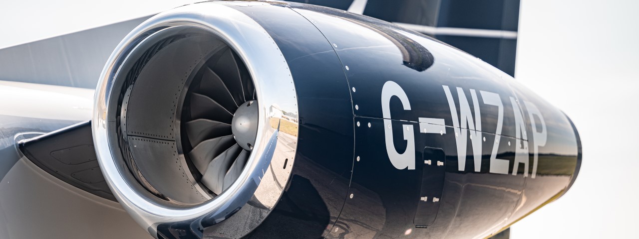 Close up to the black private jet G-WZAP engine.