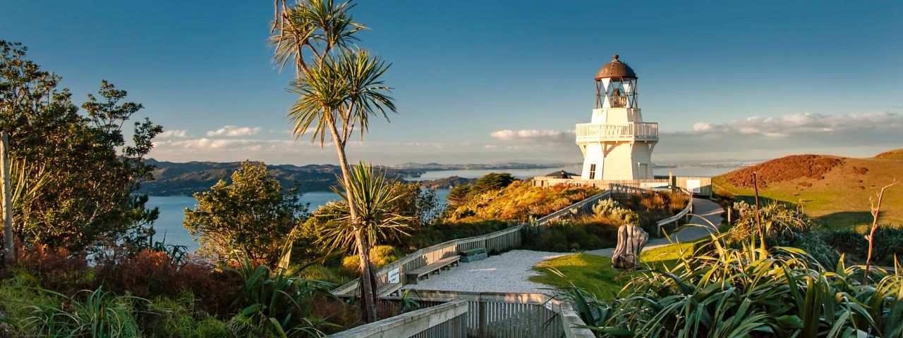 A scenic path leading to the Manukau Heads Lighthouse in Auckland, New Zealand.