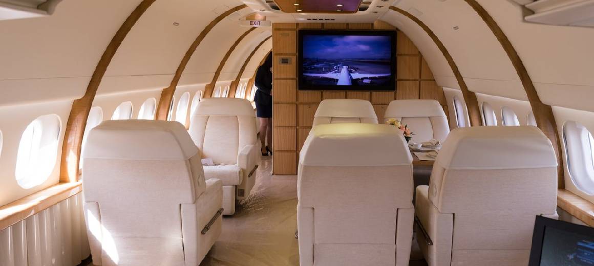 Interior view of private jet with white leather seats