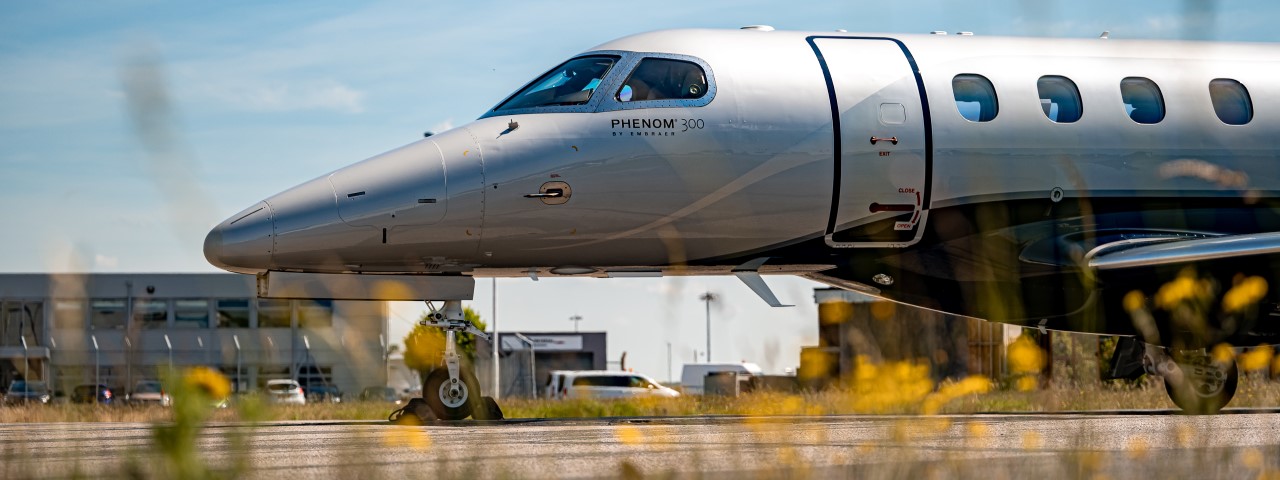 The side view of the private jet on a runway.