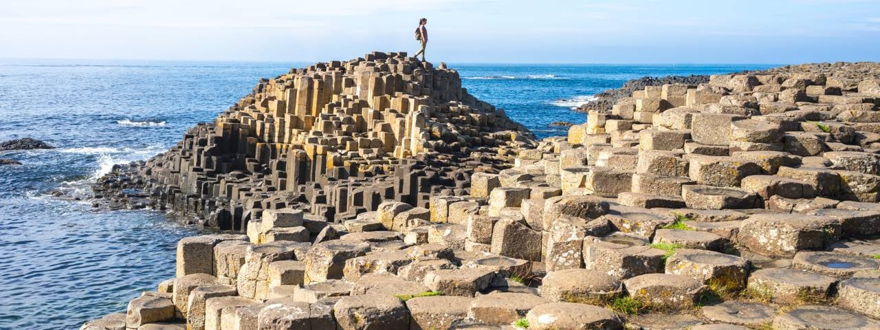A person walking on the Giant’s Causeway.