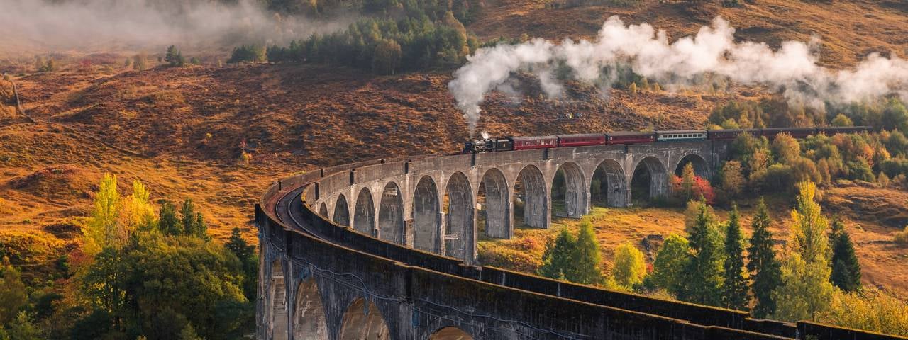 A steam train traveling along the Glenfinnan Viaduct, which features in the Harry Potter movies.