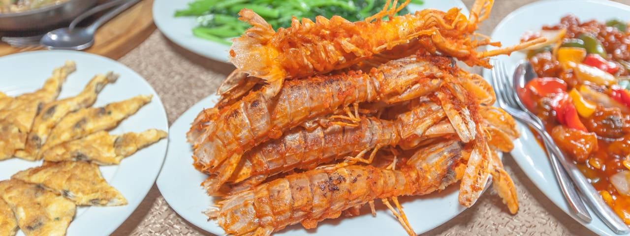 A Thai food platter with fried mantis shrimp, prawn soup and other dishes.